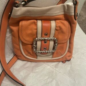 B. Makowsky 
Orange and Cream Leather Crossbody Bag
8.5”H X 9”L  47” strap
